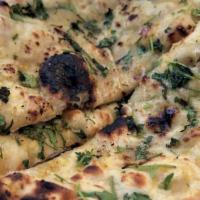 Garlic Naan · Fresh bread baked in clay oven topped with fresh garlic and cilantro.