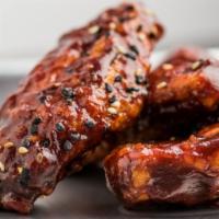DMZ Wings · Spicy level two. Habanero infused BBQ sauce, black pepper, sesame seeds.