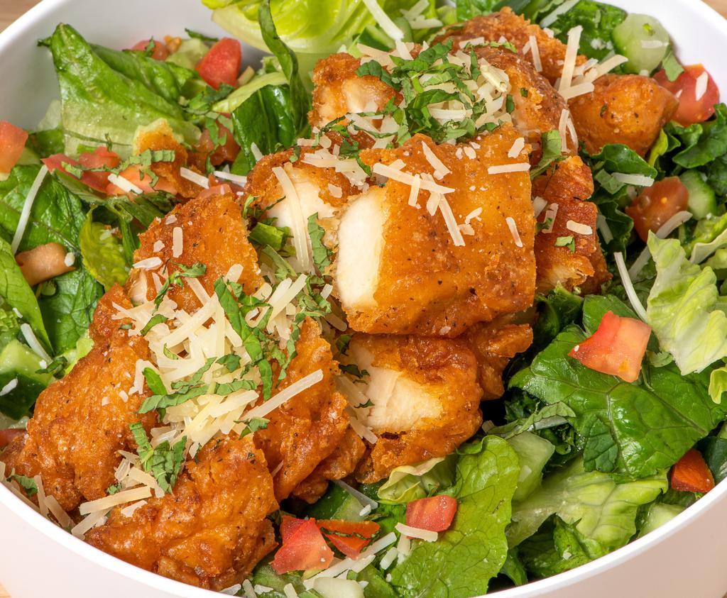 Fried Chicken Salad · Crispy fried chicken, kale, romaine, diced tomatoes, cucumber, mint, and shredded parmesan. Served with black pepper parmesan dressing on the side.