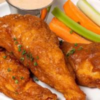 Chicken Strips · Fried chicken strips served with house sauce, celery, and carrots.