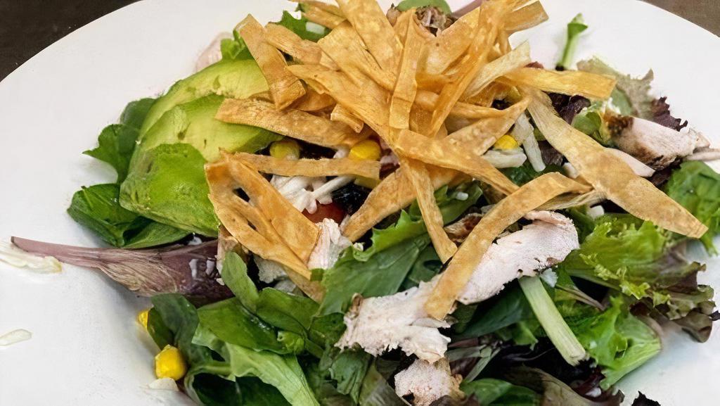 Santa Fe Chicken Salad* · Chopped chicken breast and mixed greens with corn, black beants, tomato, Jack cheese, and crispy homemade tortilla strips. Tossed in our line-cilantro vinaigrette and topped with fresh avocado.