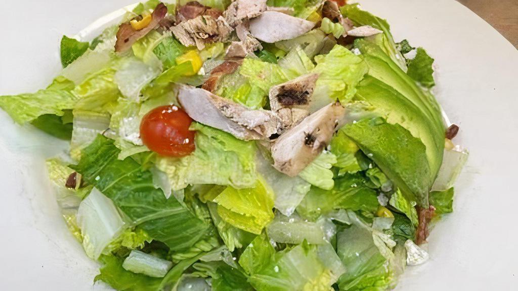Cobb Salad* · Turkey, ham, bacon, blue cheese crumble, cheddar cheese, avocado, tomato, chopped romaine tossed with your choice of dressing.