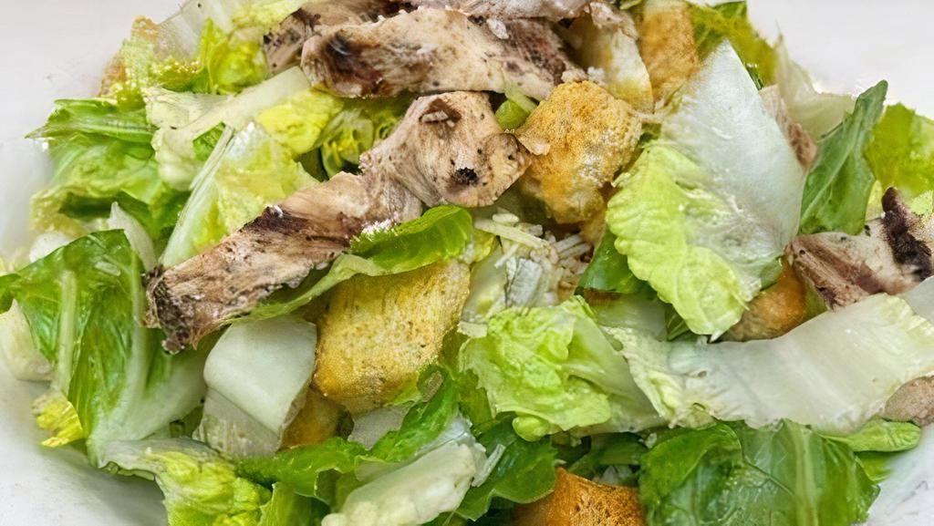 Chicken Caesar Salad* · Crisp chilled romaine lettuce, croutons, grated Parmesan cheese and tossed with our creamy Caesar dressing.