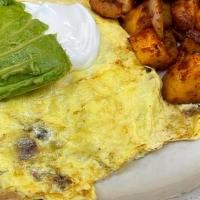 Bacado Omelette* · Filled with bacon and jack cheese topped with Avocado and sour cream