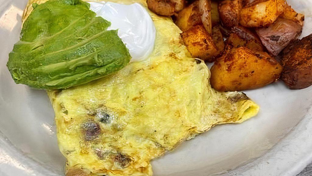 Bacado Omelette* · Filled with bacon and jack cheese topped with Avocado and sour cream