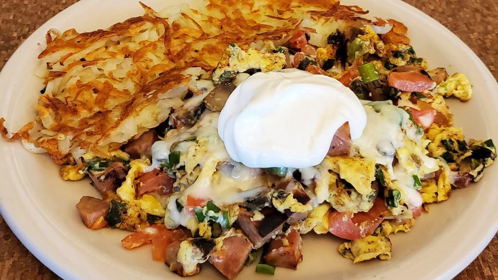 Santa Ana Scramble · Chicken apple sausage, mushrooms, green onions, tomatoes, jack cheese, topped with sour cream.