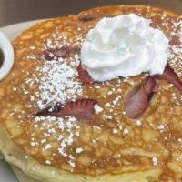 Fruit Pancakes* · Choose from strawberry, blueberry or banana. Topped with whipped cream and powdered sugar.