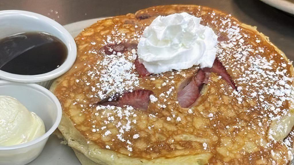 Fruit Pancakes* · Choose from strawberry, blueberry or banana. Topped with whipped cream and powdered sugar.