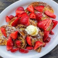 Strawberry French Toast · French toast with a hint of orange zest. Topped with fresh strawberries, powdered sugar, and...