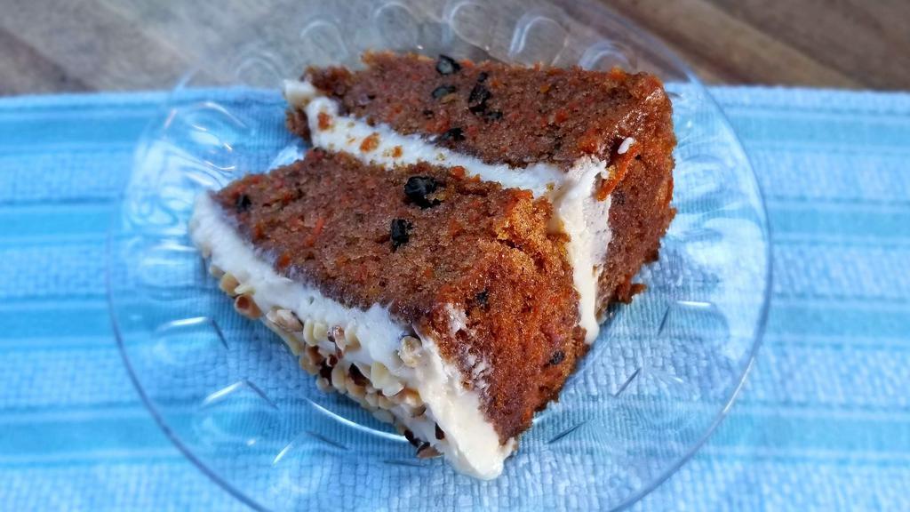 Carrot Cake · A house favorite! Contains pecans and topped with decadent cream cheese frosting and toasted almonds.