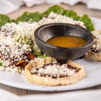 Botana Oaxaquena · Two deep-fried cheese empanadas, two deep-fried chicken taquitos, two molotes with chorizo p...