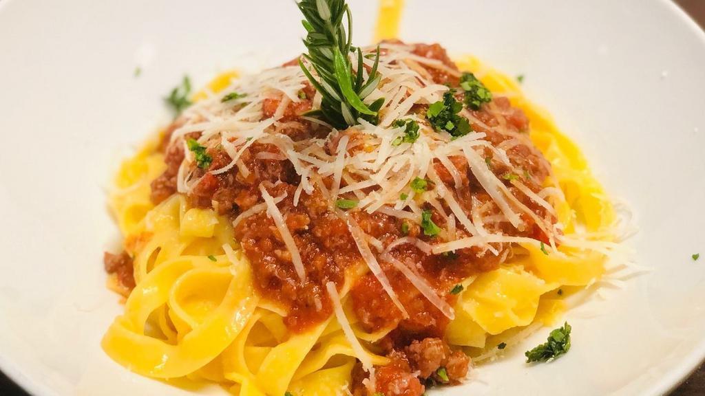 Tagliatelle al Sugo con Polpettine · fresh organic Roma tomato sauce & veal mini meatballs topped with Pecorino Romano cheese