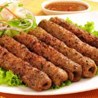 Beef Kabab · Hot & Tasty Beef kabab cooked to perfection. Served on a bed of rice with a side of salad.
