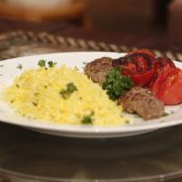 Lamb Kabab · Hot & Tasty Lamb kabab cooked to perfection. Served on a bed of rice with a side of salad.