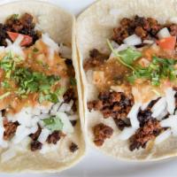 Chorizo Tacos · spicy Mexican pork sausage w/ chipotle salsa, cilantro, onions, and lime