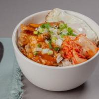 Orange Chicken Bowl · A bowl filled with orange chicken over steamed rice, with kimchi, scallions, and fried egg.