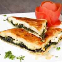 Spanakopita · Spinach pie with layers of buttered filo pastry filled with spinach, onions, feta cheese, an...
