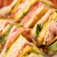 Sazon Club · Turkey, ham, cheese, mayo, mustard, lettuce, tomatoes and bacon. Sliced in 3 pcs of sourdoug...