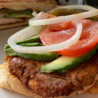 Torta de Milanesa · Seasoned and lightly fried chicken breast served on Telera bread and includes Oaxaca Cheese,...
