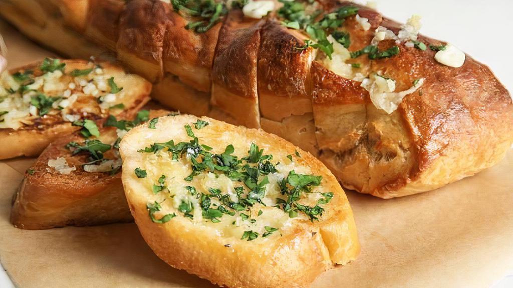 Garlic Bread · Toasted bread topped with garlic pesto and mozzarella cheese.