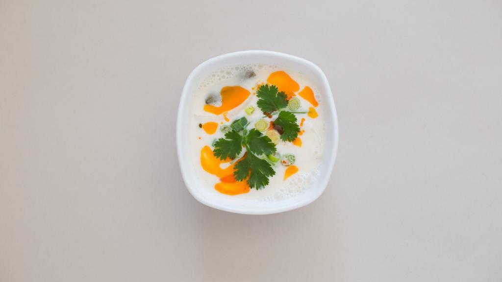Tom Kha · Coconut soup with chicken, lemongrass, kaffir lime leaves, onion and mushrooms.