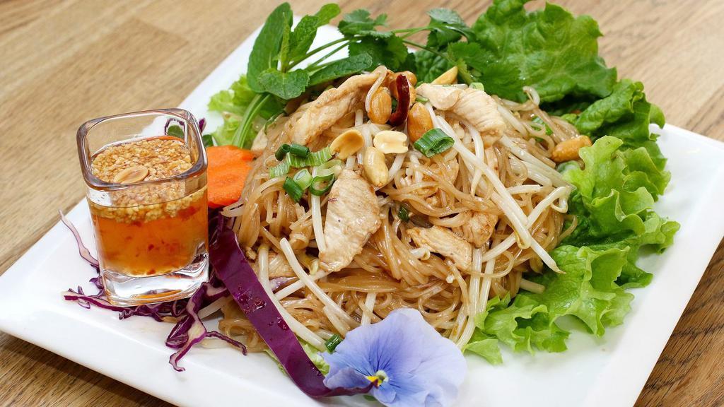 Pad Mee Lao · Laos version fried noodle. Small rice noodle with chicken, bean sprout green onion, black beans sauce. Served with fresh vegetables. Try it with papaya salad.