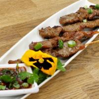 Moo Ping · Grilled pork. Grilled marinated pork on skewers. Served with spicy tamarind sauce.