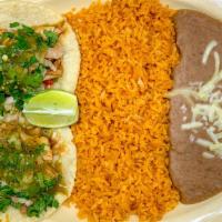 Taco Plate · Two tacos served with a side of rice and beans.