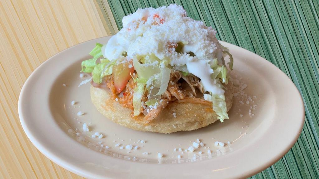 Sope · Handmade thick corn tortilla with your choice of meat topped with lettuce, pico de gallo, sour cream and Cotija cheese.