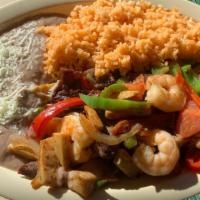 Fajitas Trio · Steak, chicken and shrimp  grilled with onions, bell peppers and tomatoes. Served with rice,...