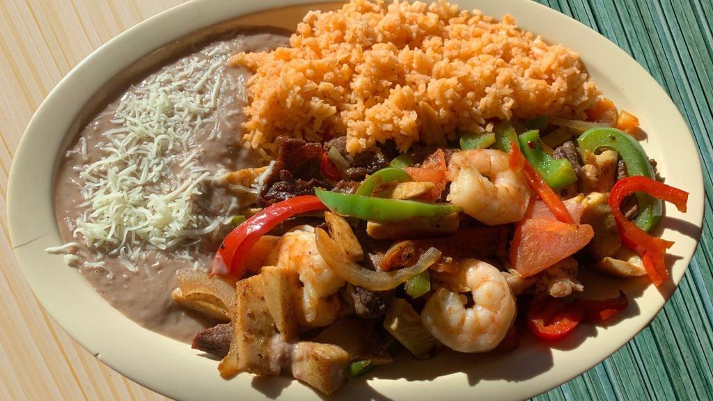 Fajitas Trio · Steak, chicken and shrimp  grilled with onions, bell peppers and tomatoes. Served with rice, refried beans and  handmade corn tortillas.