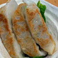 Gyoza  · Pan fried pork and vegetable pot stickers.