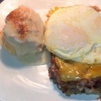 Eggs Over My Hash · Crispy hash browns topped with corned beef hash, two eggs any style, cheddar cheese, and gre...
