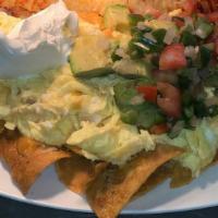 Chilaquiles · Tortilla chips tossed in a spicy red sauce and cheddar cheese. two eggs cooked any style, to...