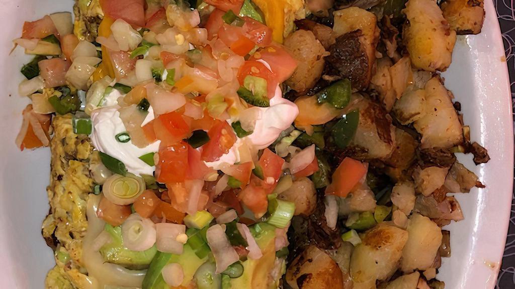 Tostada Scramble · Two crispy corn tortillas topped with chili and two eggs scrambled with chorizo, green onions,  jalapenos, jack, and cheddar cheese. topped with avocado and sour cream and homemade salsa. Includes hash browns or country potatoes.