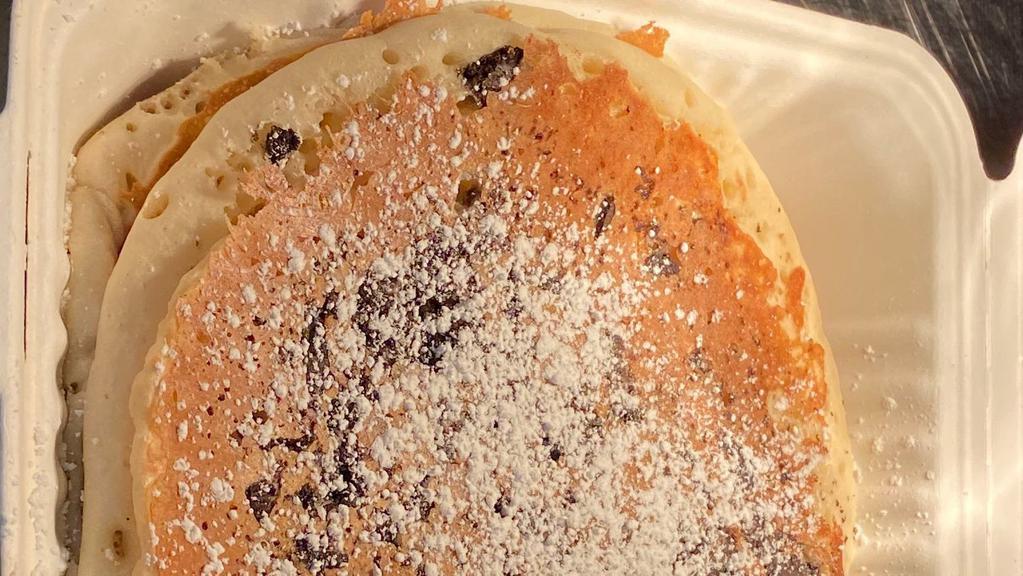 Chocolate Chip Pancakes · Two Golden Buttermilk Pancakes Stuffed with Chocolate chips. Topped with Powder Sugar Served with Butter and Syrup.