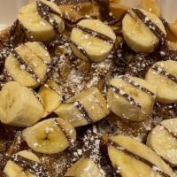 Banana Bomb Waffle · Topped with sliced bananas, peanut butter and nutella.