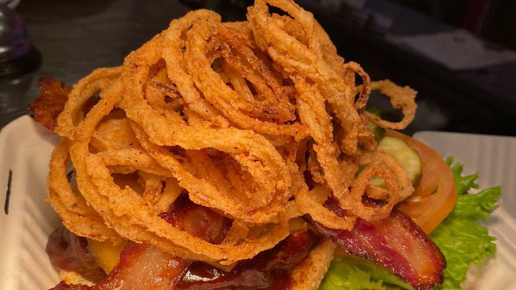 Cowboy Burger · Cheddar cheese bacon, onion straws and BBQ sauce.
Western style burger. 100% certified angus beef.