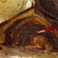 The Reuben · Corned beef or pastrami with melted Swiss cheese and sauerkraut.