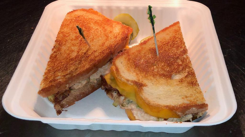 Tuna Melt · Tuna salad and melted cheddar cheese on grilled sourdough bread.