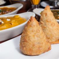 Samosa · Homemade crispy Indian pastry stuffed with spiced peas and potatoes.