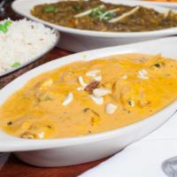 Chicken Korma · Chicken thigh cooked in a rich, creamy tomato and onion paste garnish with cashew and raisins.