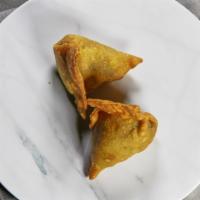Veggie Samosa (Stuffed Pastries) · Cumin flavored potatoes and peas wrapped in a flaky pastry. Served with tamarind mint sauce.