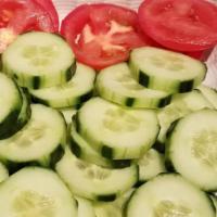 Cucumber Salad · Cucumber, red onion and tomato with homemade dressing.