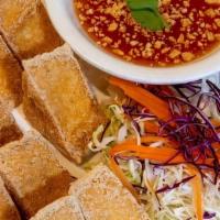 03 - FRIED TOFU · Deep-fried fresh tofu triangles served with sweet chili sauce and a side of chopped peanuts