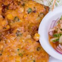 06 - CORN CAKES · Fritters (4) made with corn kernels, chopped green beans, kaffir lime leaves, chili paste, a...