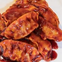 07 - PAN FRIED DUMPLINGS · Pan-fried Thai-spiced chicken or pork dumplings (8) tossed in our house glaze