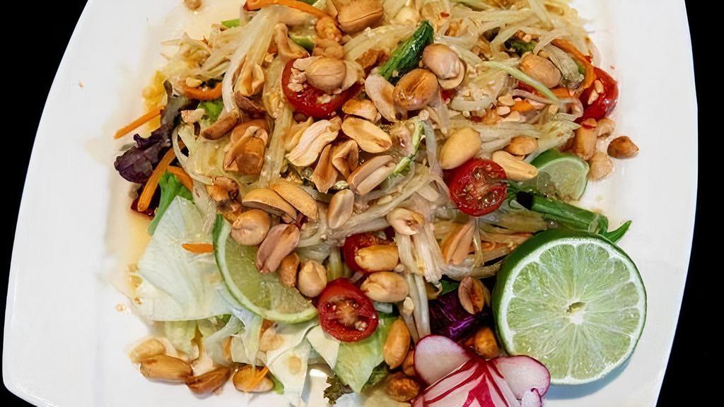 27 - PAPAYA SALAD · Shredded green papaya with minced garlic, crushed peanuts, grape tomato, carrot, sliced green beans, and fresh Thai chili, dressed in fresh lime juice, topped with roasted peanuts, served on a fresh mixed green salad