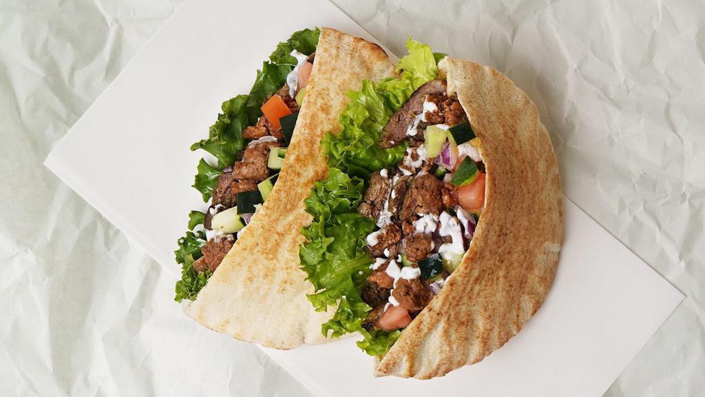 Beef & Lamb Gyro Pita Sandwich · Beef & lamb gyro on a pita with lettuce, tomato, onion, and your choice of sauce.