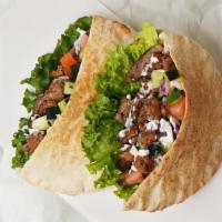 Deluxe Pita Sandwich · Your choice of 2 proteins on a pita with lettuce, tomato, onion, and your choice of sauce.